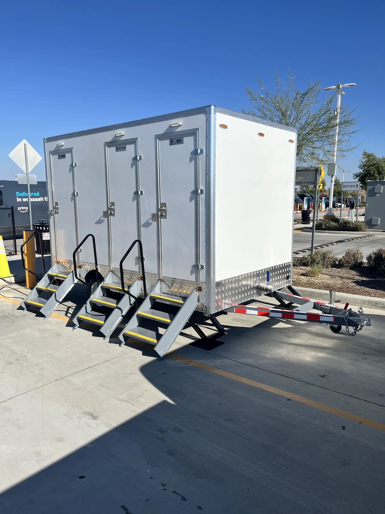 Three-stall Lux Loos restroom trailer with steps deployed